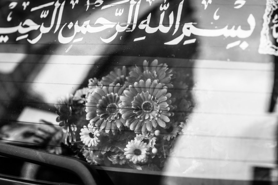 Dried flower arrangement gracing the back window of a car