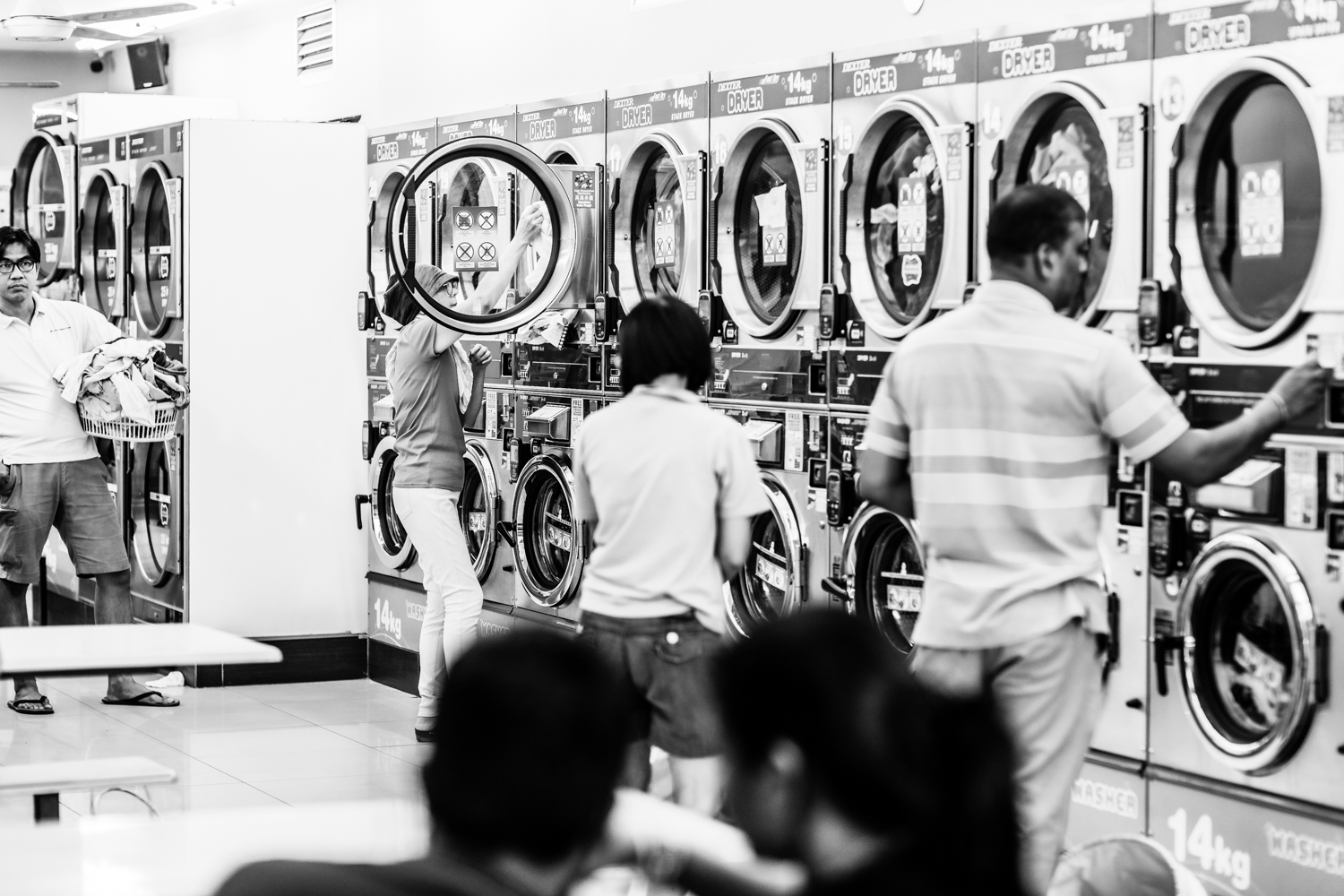 Washing day at a self service 24 hour laundromat in Taman Tun Dr. Ismail township in Kuala Lumpur, Malaysia