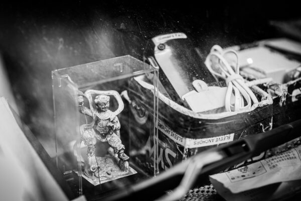 Deity encased in plastic box, container of sleeve anchors on a vehicle dashboard in Kuala Lumpur Malaysia