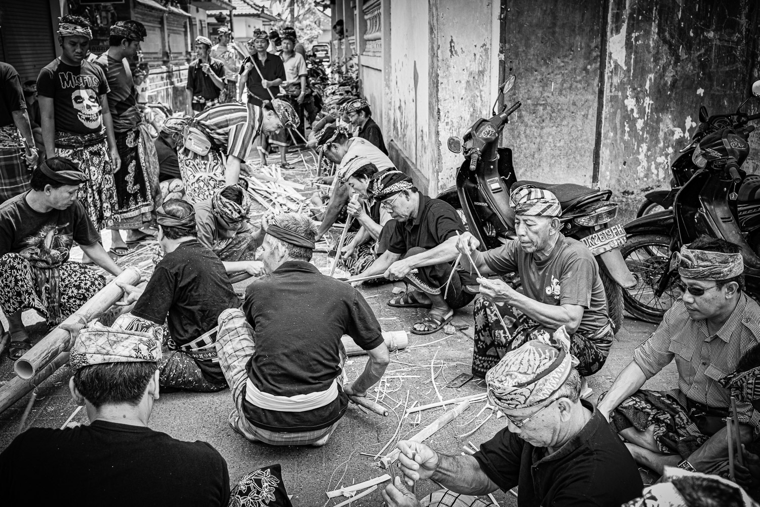 Ngaben cremation in Bali, community members working together to make the bamboo stretcher for the deceased