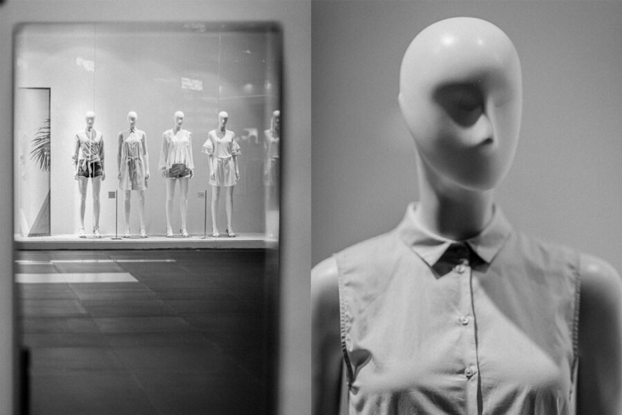 Mannequins in shop display window, black and white photo
