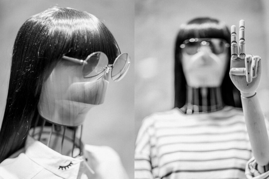 Shop mannequin modelling sunglasses and doing the peace sign black and white photo