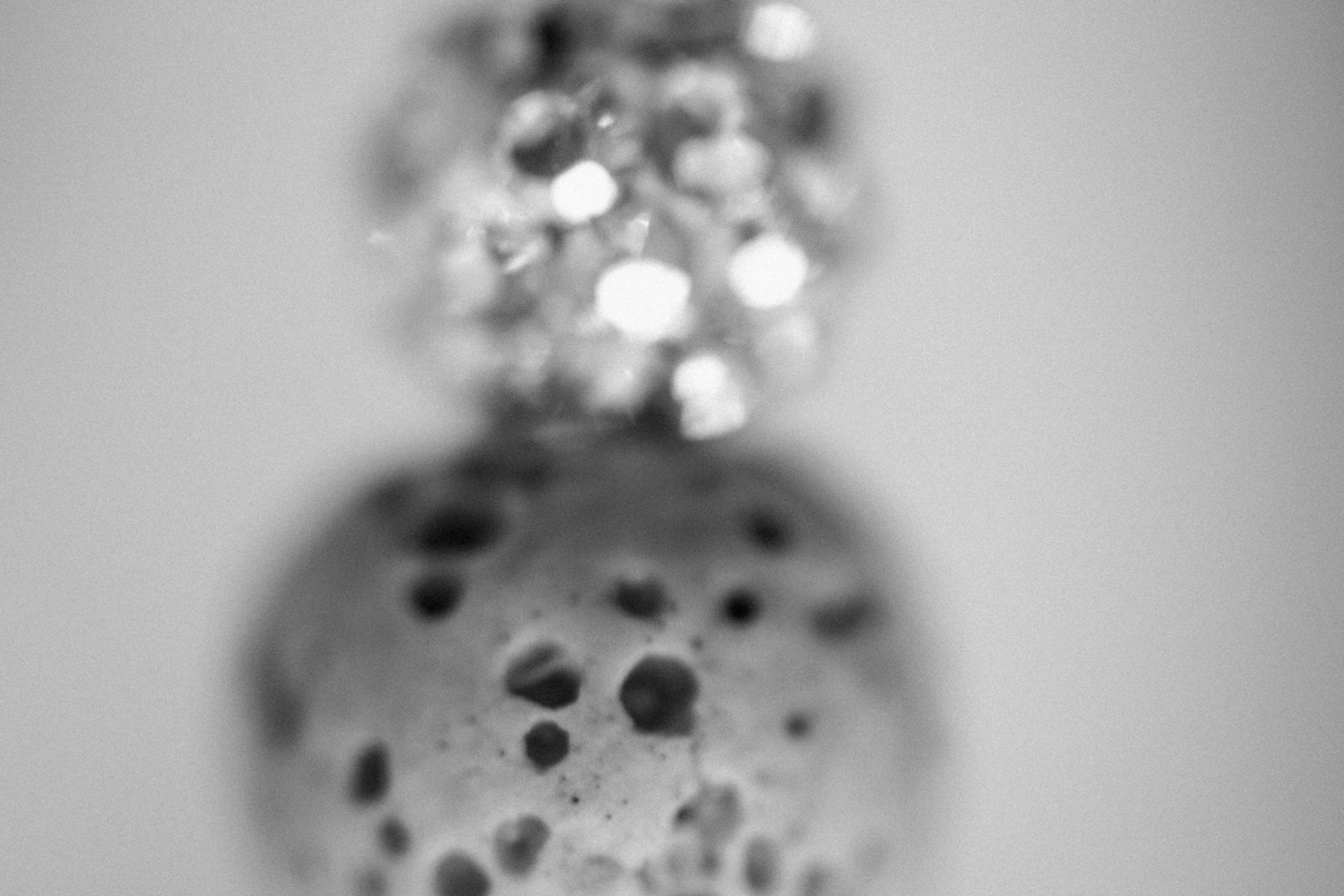 Fine art spheres in black and white. Imagery features a found lava stone and bead.