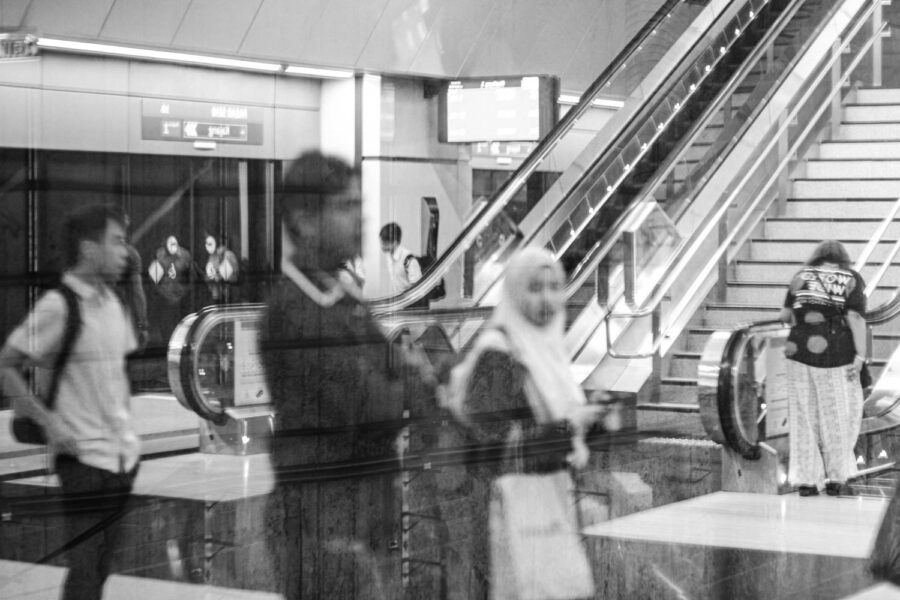 Rail street photography reflection of people waiting for a train at a MRT platform in KL Malaysia
