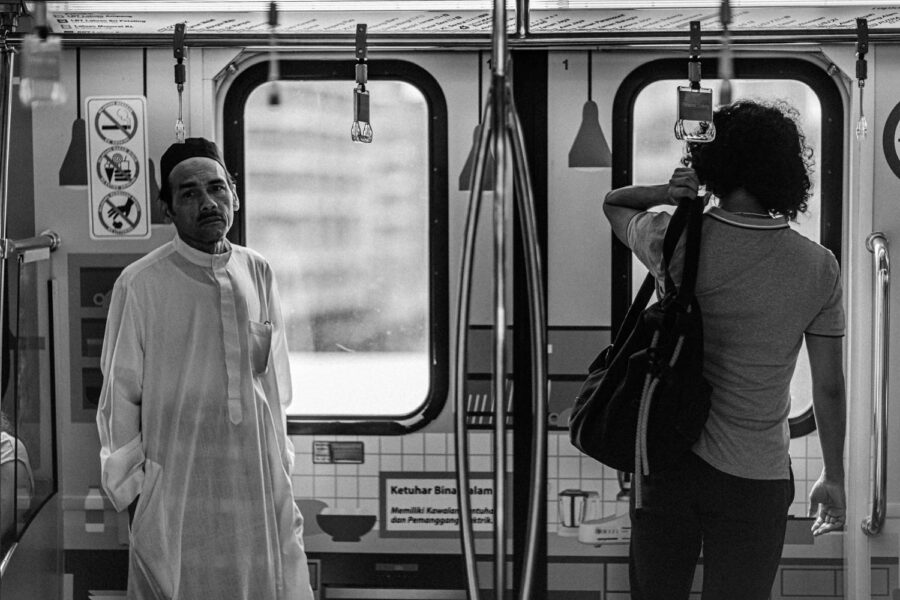 Rail train two men on the LRT rail train in KL Kuala Lumpur Malaysia