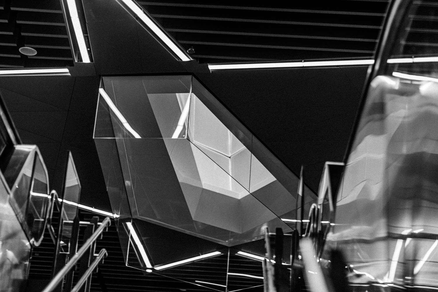 Train station photography black and white photo of stairs and escalator on an MRT platform