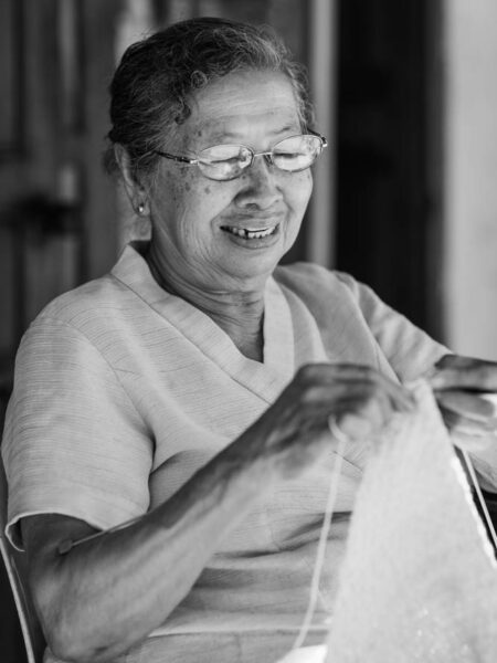 Portrait of woman knitting a jumper for the monks