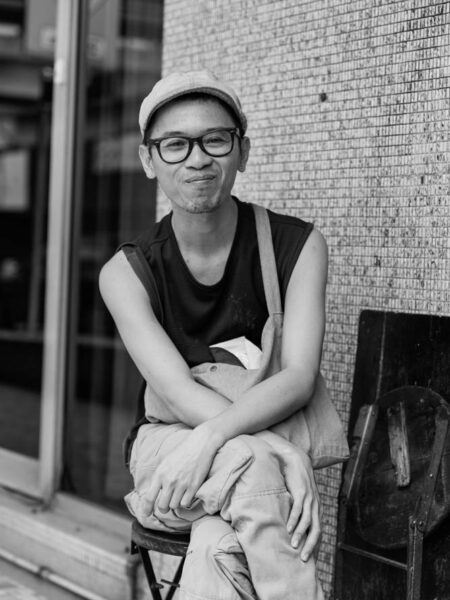 Portrait man sitting at key kiosk in chinatown