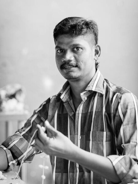 Portrait man stringing jasmine flowers in brickfields kuala lumpur