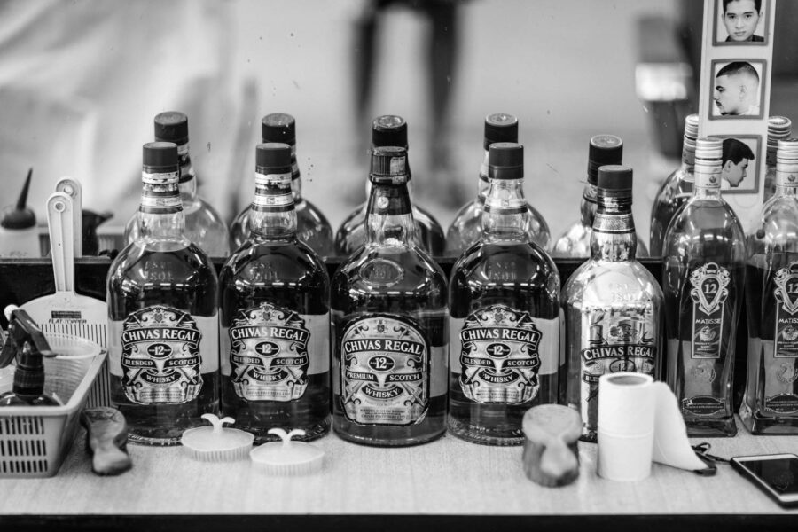 Barber shop display bottles of Chivas Regal Scotch Whisky Little India, Brickfields, Kuala Lumpur – Malaysia