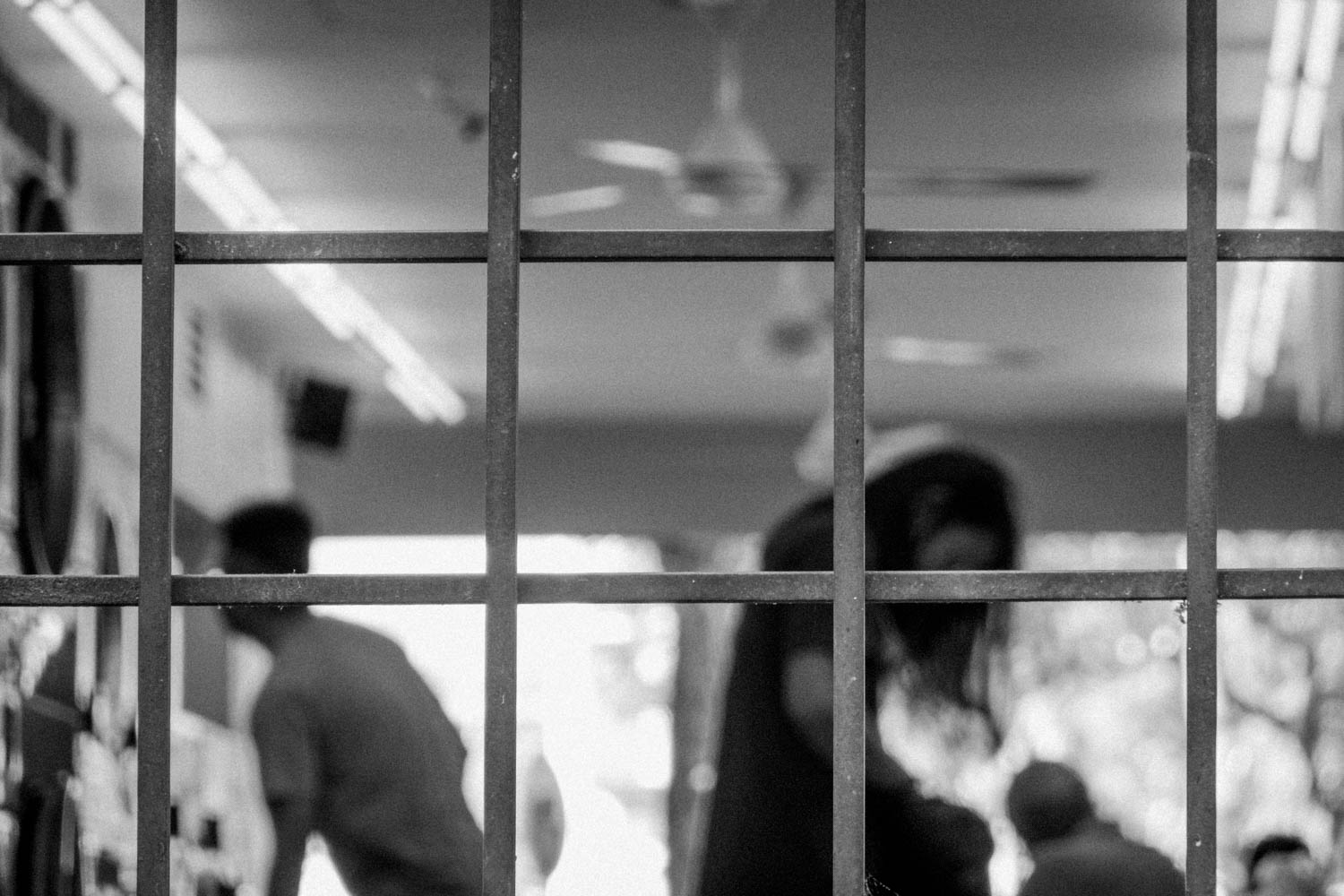 24 hour laundromat customers during their laundry. Black and white street photography Taman Tun Dr Ismail [TTDI] Kuala Lumpur - Malaysia