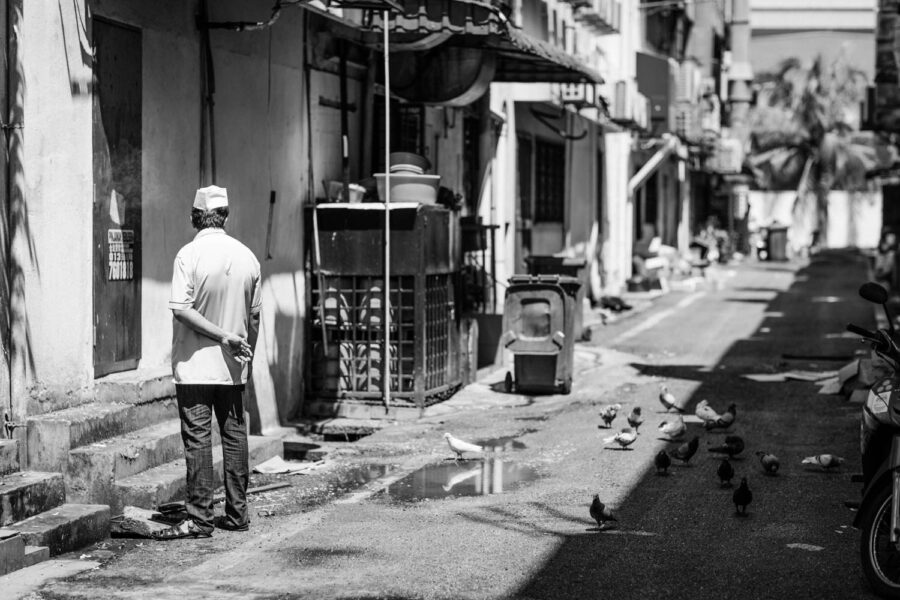 Chef on a smoking break at the back of the restaurant. Black and white street photography - Taman Tun Dr Ismail [TTDI] Kuala Lumpur - Malaysia