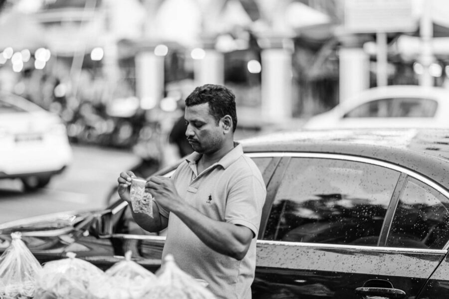 Man packaging snacks Little India, Brickfields, Kuala Lumpur – Malaysia