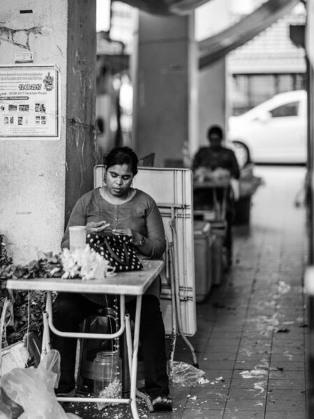 Women threading jasmine flowers in Little India, Brickfields, Kuala Lumpur – Malaysia