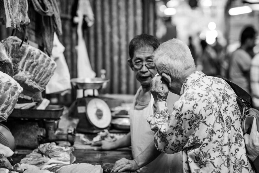 Man buying fresh meat at the wet market in Pasar Seni, Kuala Lumpur – Malaysia