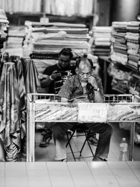 Man selling material in Petaling Street, Chinatown Kuala Lumpur - Malaysia