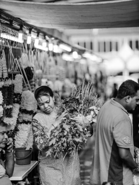 Woman walking with flower stems in Little India, Brickfields - Kuala Lumpur
