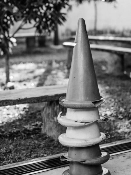 Stack of five safety cones in black and white.