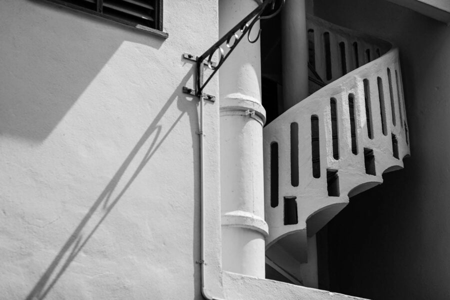 Spiral concrete stairway with shadow in black and white