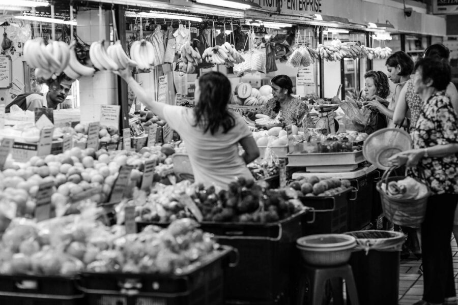 TTDI wet market fruit store shopper selecting a bunch of bananas - KL - Malaysia