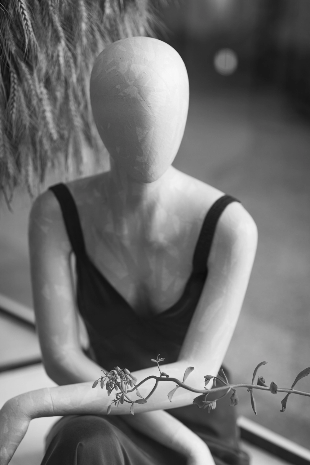A mannequin made of paper mache is wearing a silk dress.
