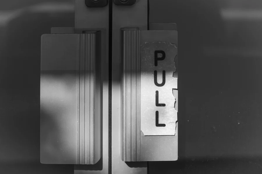 Pull to open sign on a door.