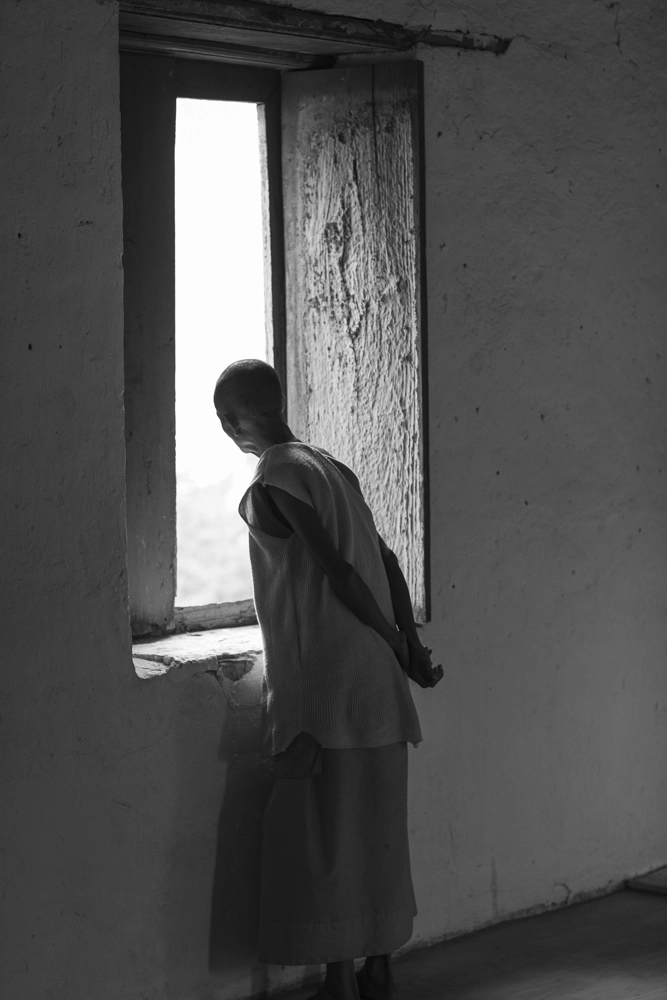 Monk looking out at the Mekong River from the Wat Chomphet temple.