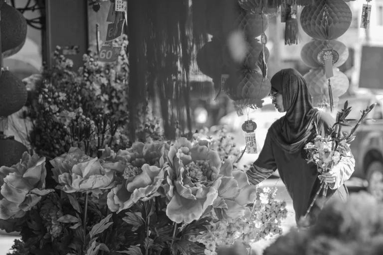 A woman selects artificial flowers for decoration.