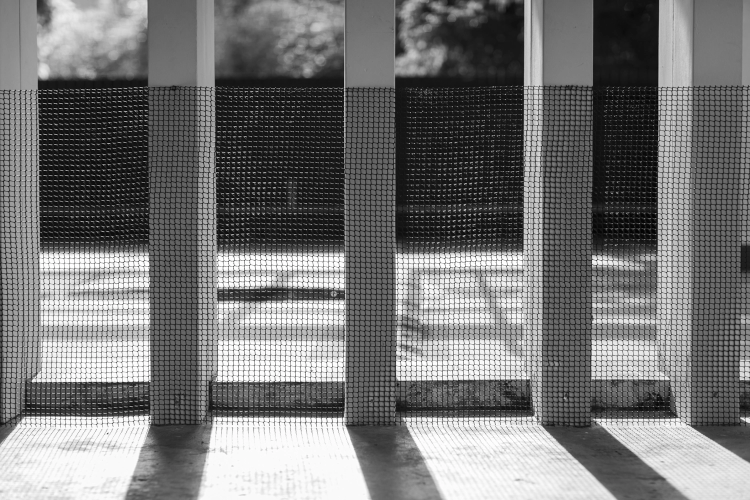 Square mesh covering pillars with lines and shadows.