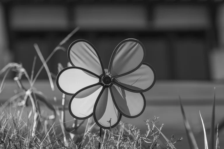 Flower-shaped windmill in a garden.