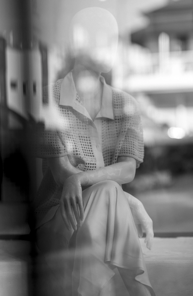 A shop mannequin is wearing a cotton grid grandpa shirt; there are reflections of James Street in the image.