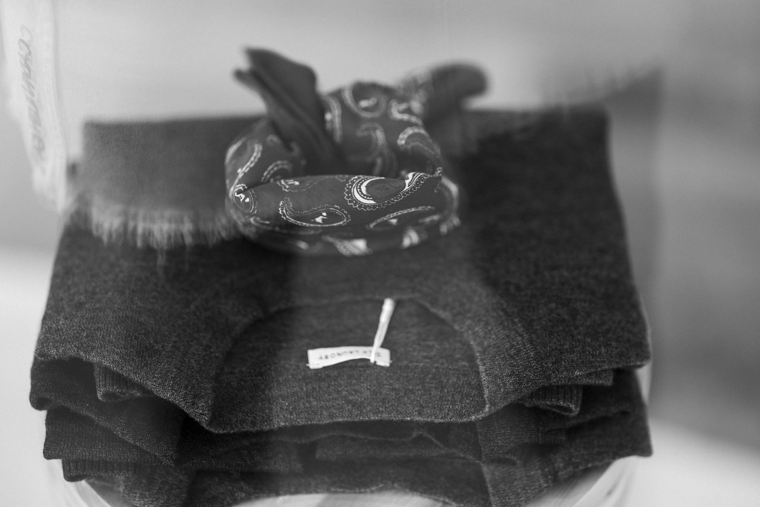 Folded knitwear and a Hounds Paisley scarf on display at Silk Laundry.