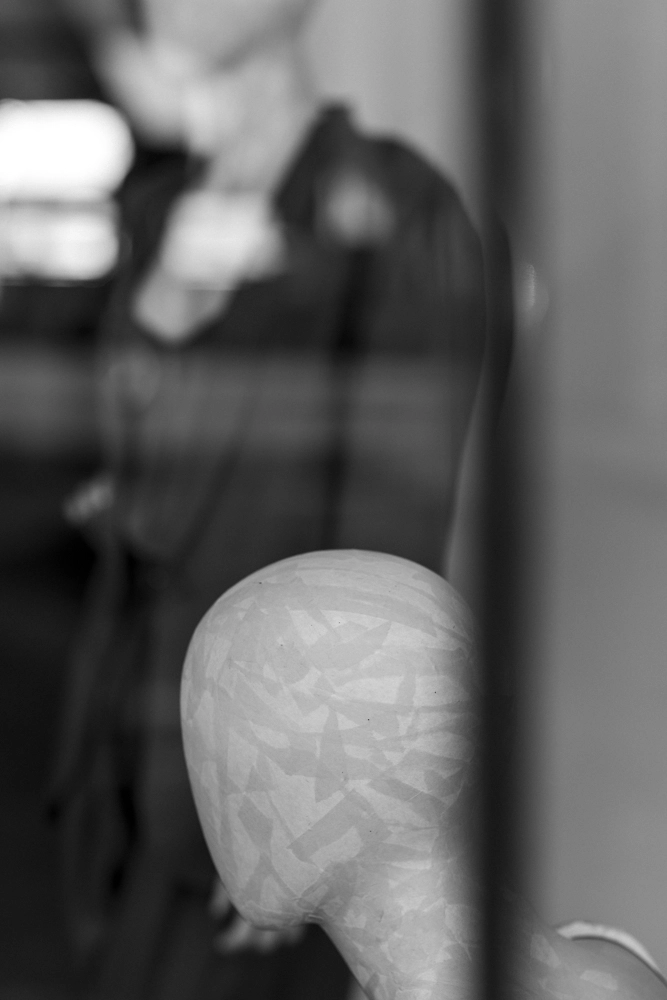 A shop mannequin with an abstract pattern head.