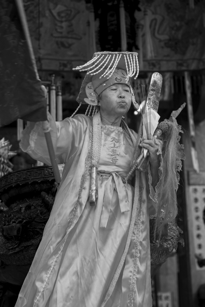 A woman burns incense sticks to purify the surroundings.