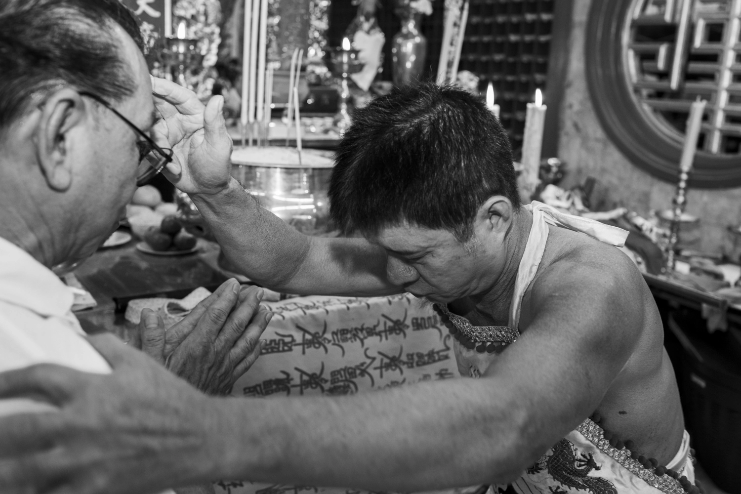A spirit medium blessing a devotee at the Phuket Vegetarian Festival.