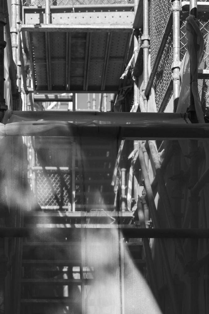 Scaffolds and barriers surrounding a construction site on Wyandra Street.