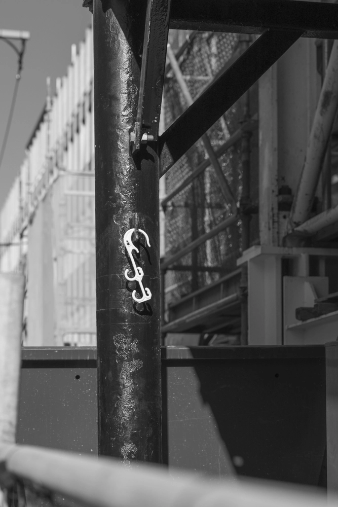 Bright yellow hooks on scaffolding, Wyandra Street, Newstead 4006