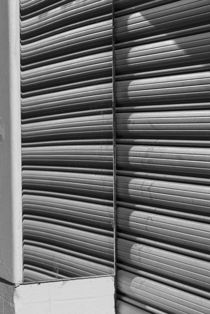 Mirrors beside a garage door.