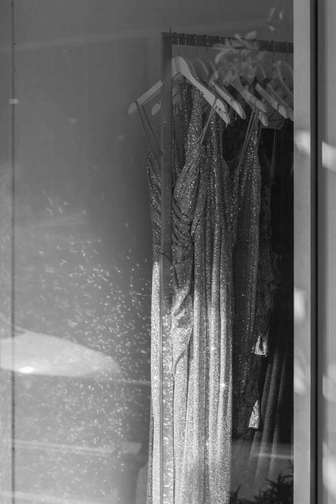 Wall lit with sparkling reflections from a sequin dress in the window of ONS Boutique.